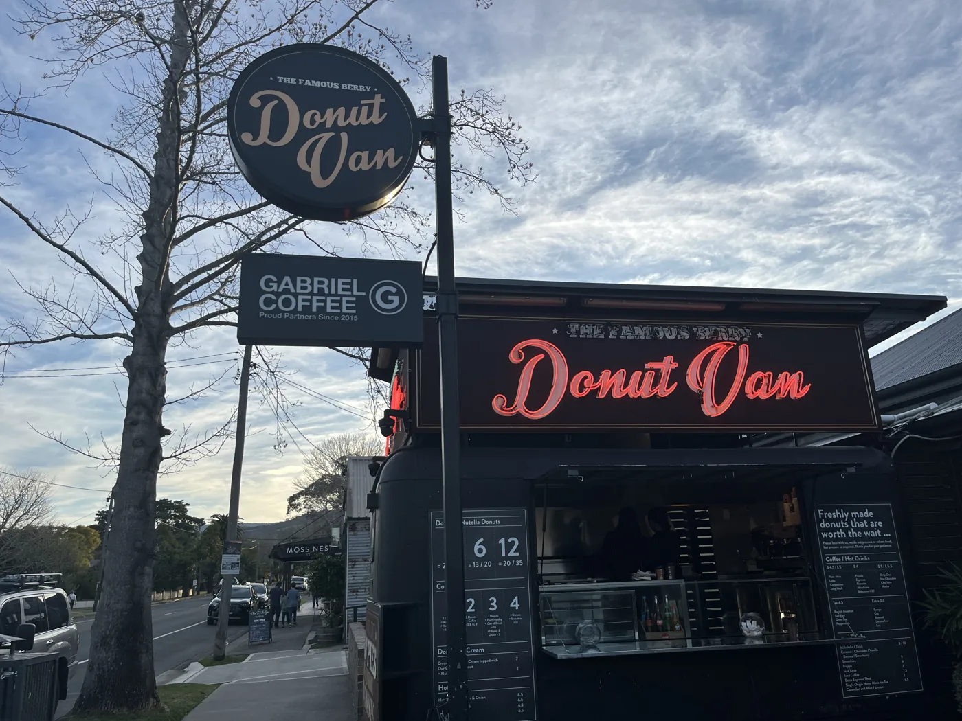 The Donut Van food truck with neon sign in a Blue Mountains town