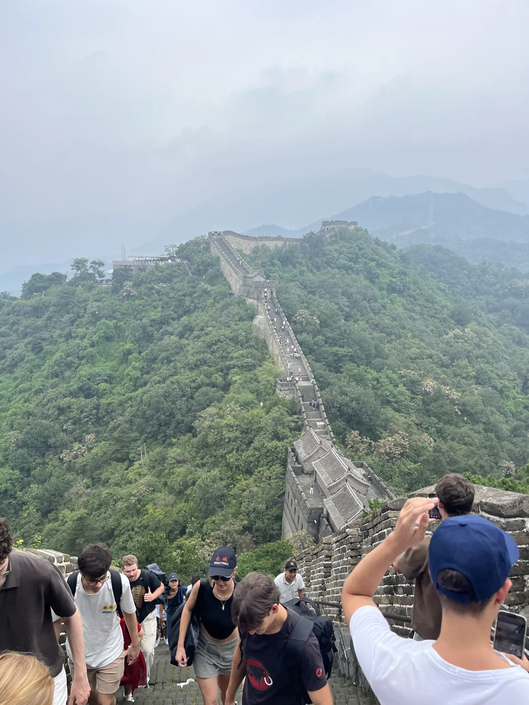 Climbing steep steps of the Great Wall at Mutianyu, Beijing