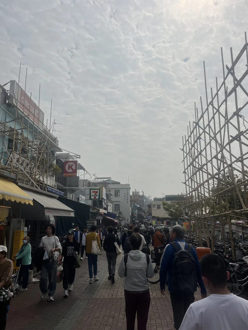 Busy Hong Kong street with bamboo scaffolding, Kowloon