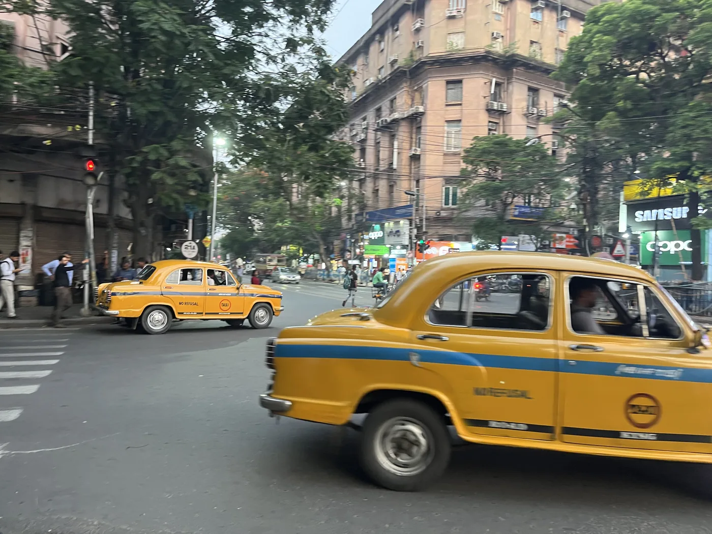 Yellow Ambassador taxis at a Kolkata intersection