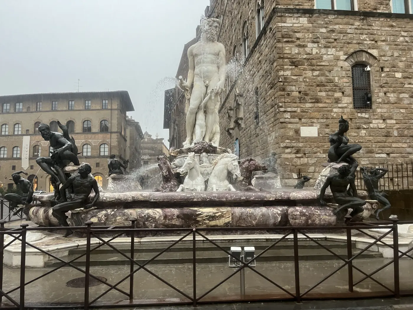 The Fountain of Neptune in Piazza della Signoria, Florence, a marble statue of Neptune surrounded by bronze satyrs