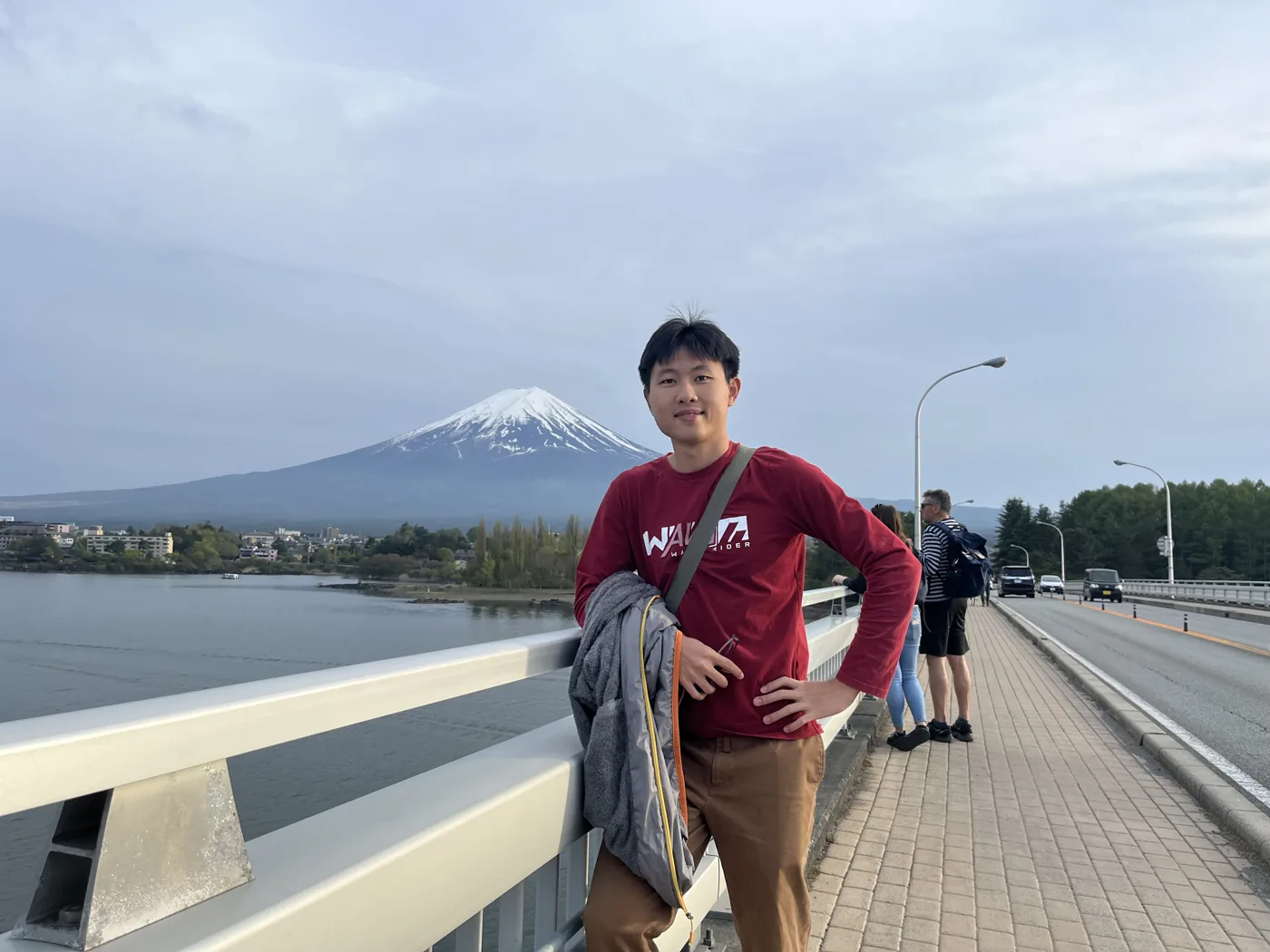 Standing on bridge with snow-capped Mt Fuji behind, Lake Kawaguchiko