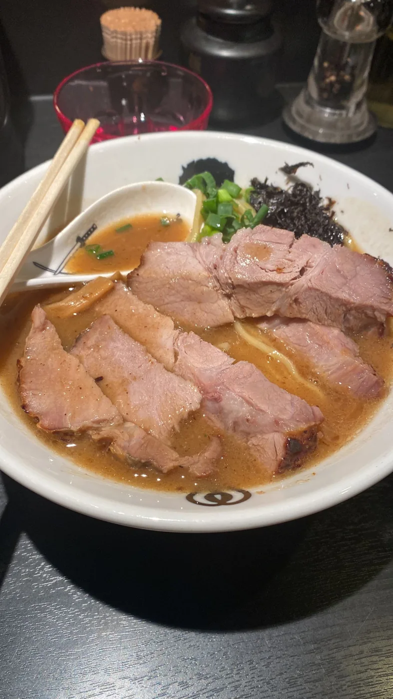 Bowl of rich tonkotsu ramen with thick chashu pork in Tokyo
