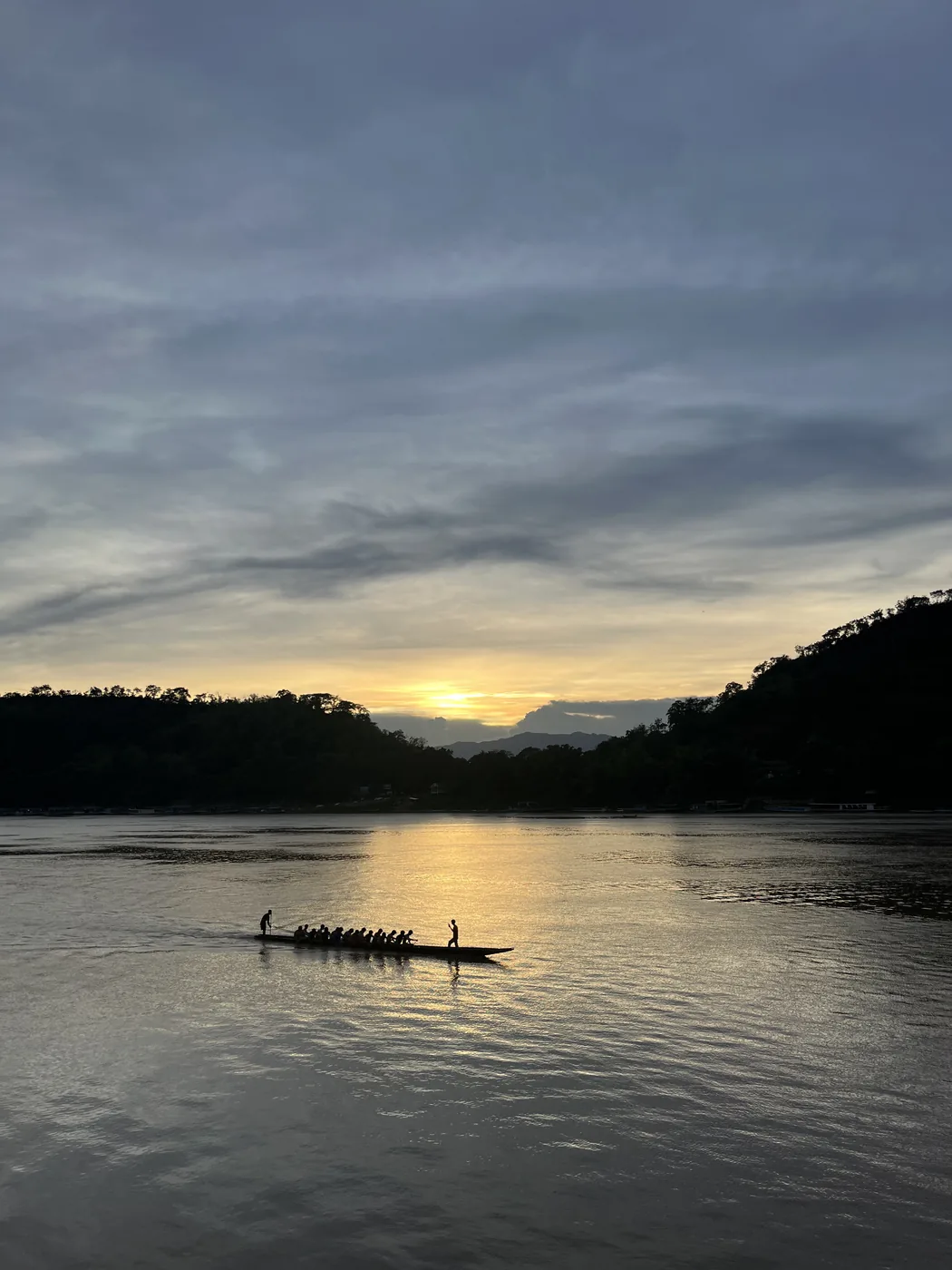 Rowing boat silhouette on the Mekong at sunset, Luang Prabang