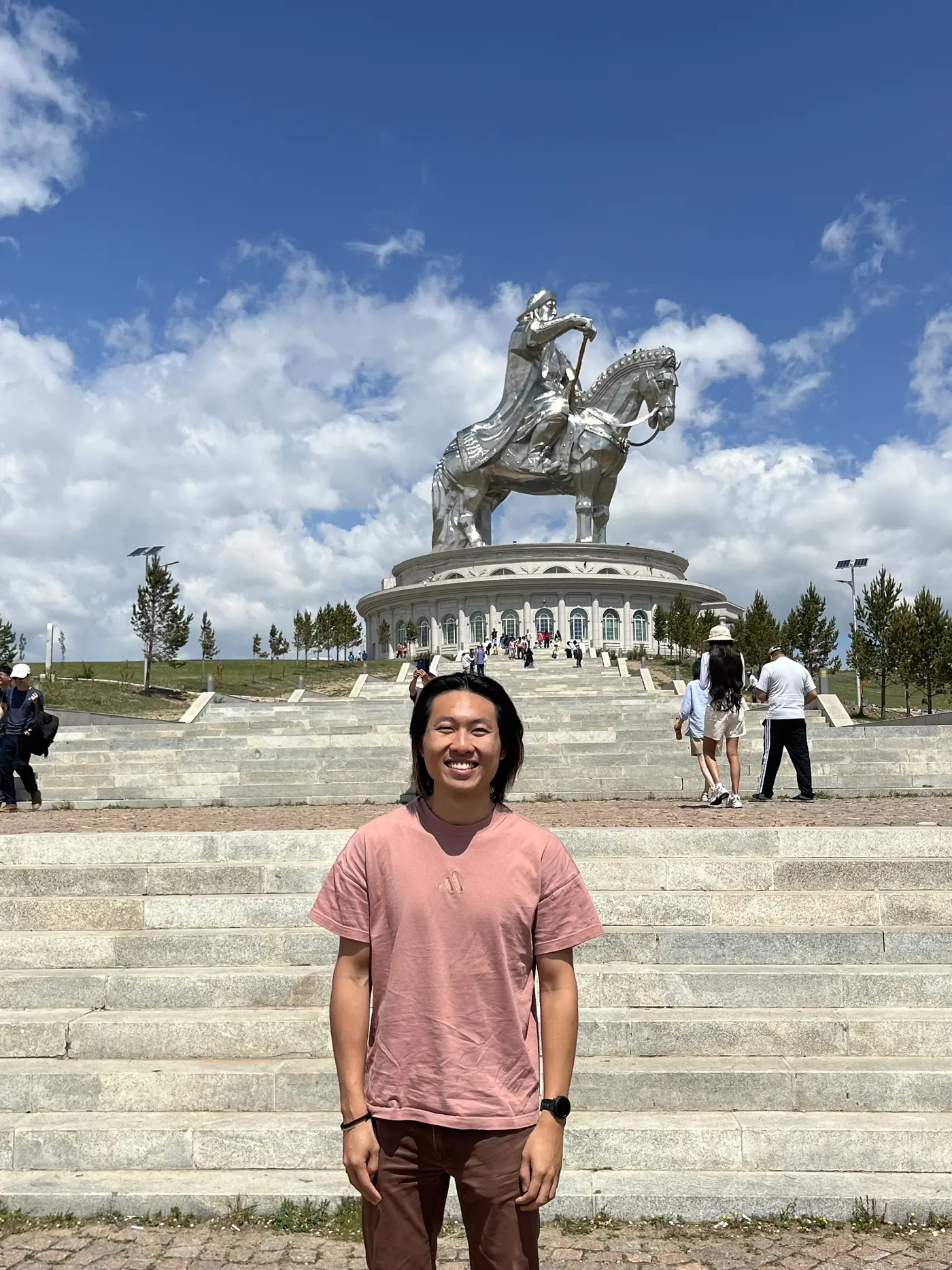 Shin on steps in front of the 40-metre silver Genghis Khan equestrian statue at Tsonjin Boldog, outside Ulaanbaatar, Mongolia