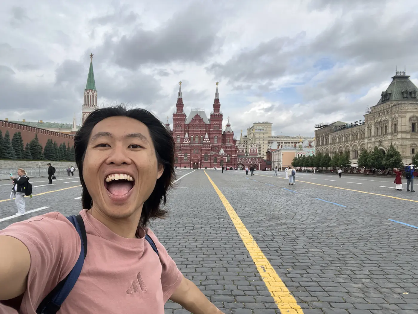 Shin excited selfie on Red Square, Moscow, with the State Historical Museum and Kremlin Nikolskaya Tower behind him