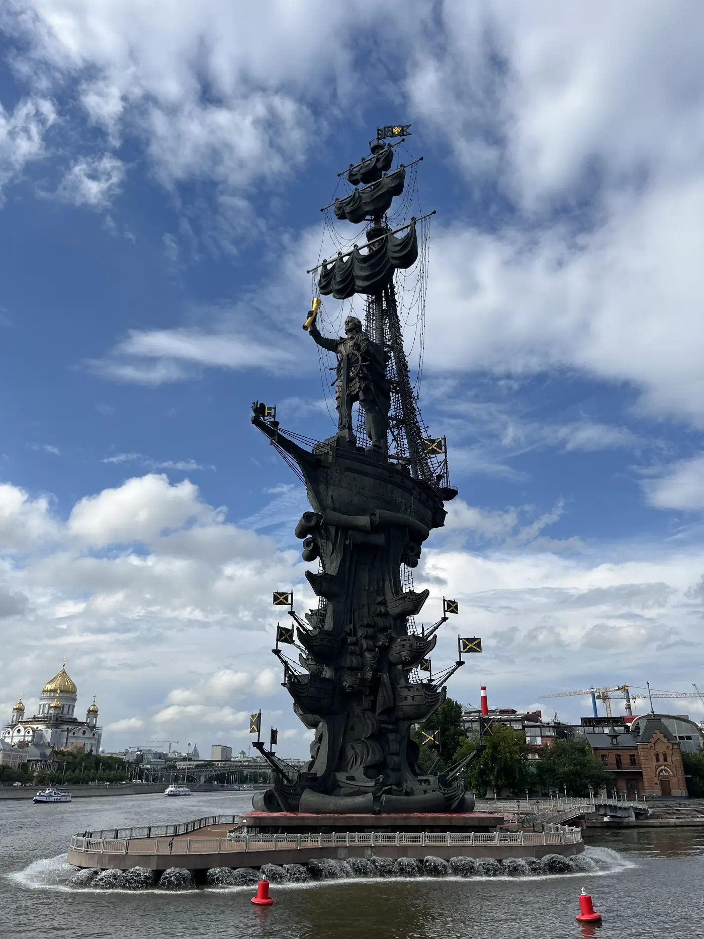 Peter the Great monument by Zurab Tsereteli on the Moscow River — towering bronze ship sculpture with golden details under blue sky