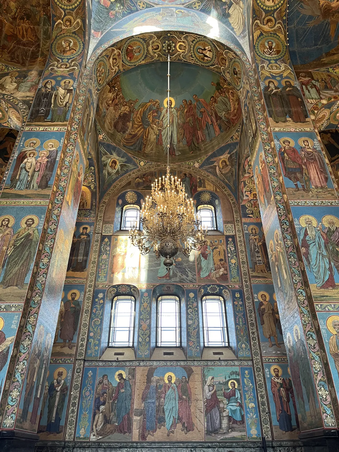 Ornate mosaic ceiling and chandelier inside the Church of the Saviour on Spilled Blood, St. Petersburg, covered floor to ceiling in Byzantine-style religious icons