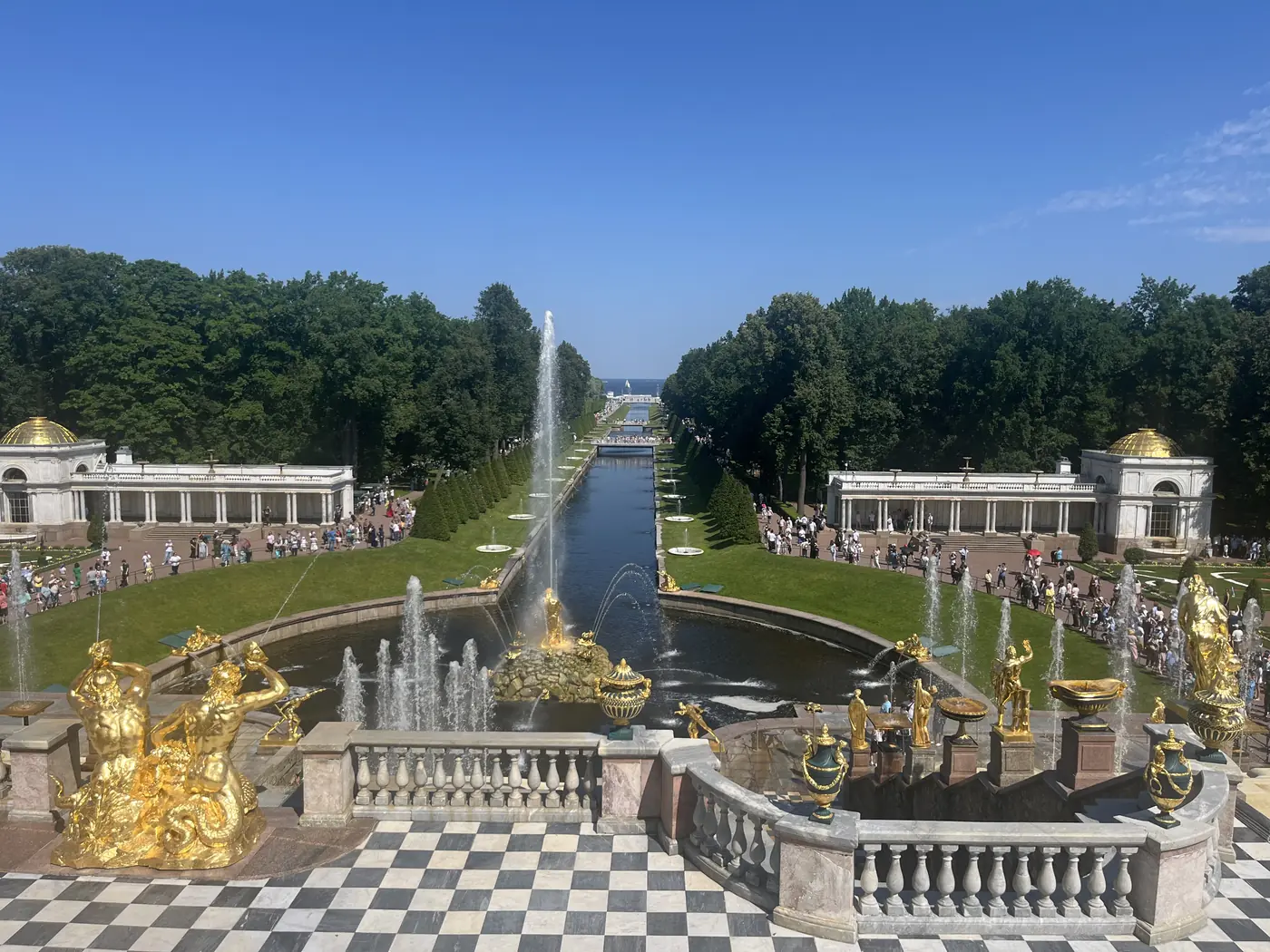 View from Peterhof Palace's terrace over the Grand Cascade's golden fountains and statues toward the sea canal and Gulf of Finland