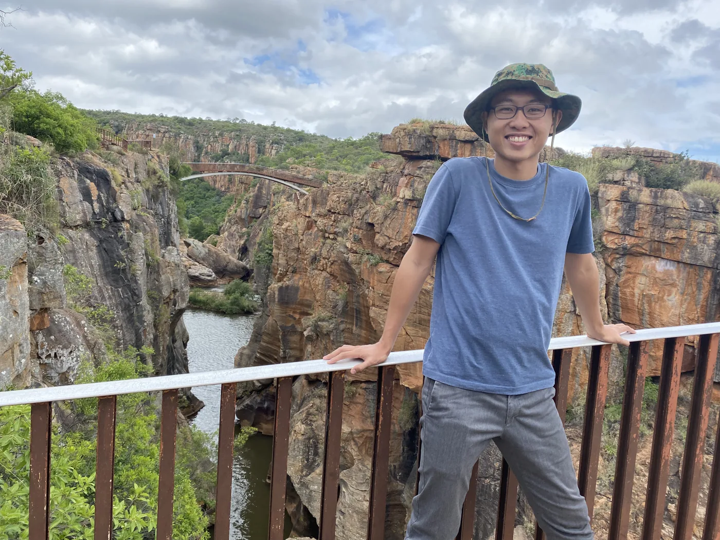 Standing at the overlook above Bourke's Luck Potholes with the canyon bridge behind