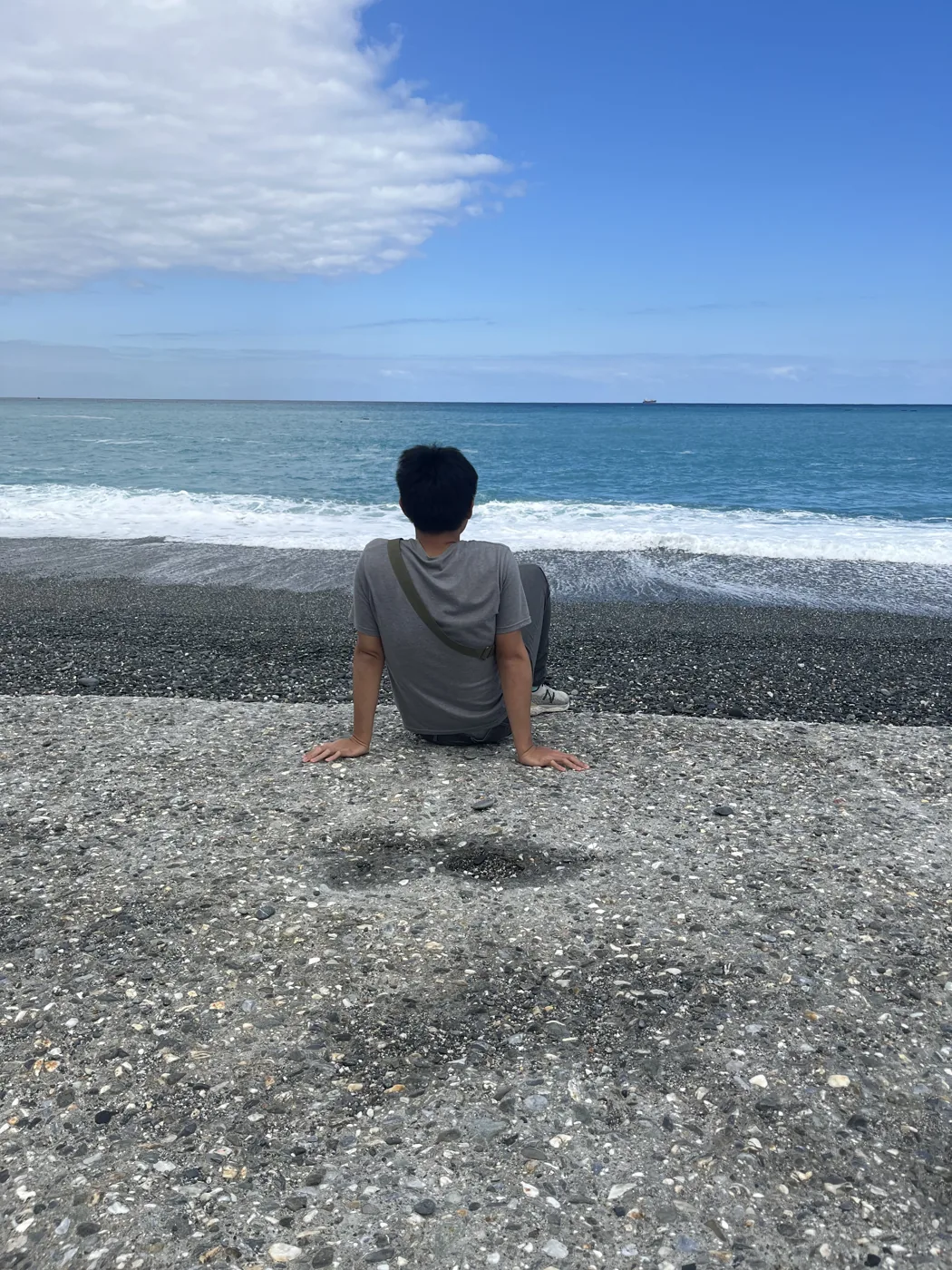 Sitting on a pebble beach looking out at the Pacific Ocean, Hualien, Taiwan