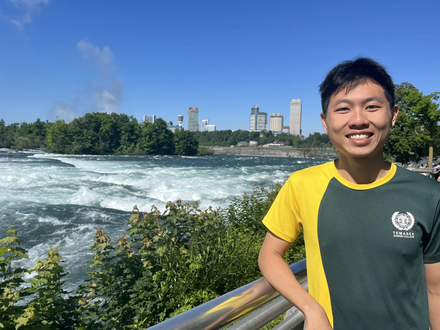 Standing at Niagara Falls with Canadian skyline behind