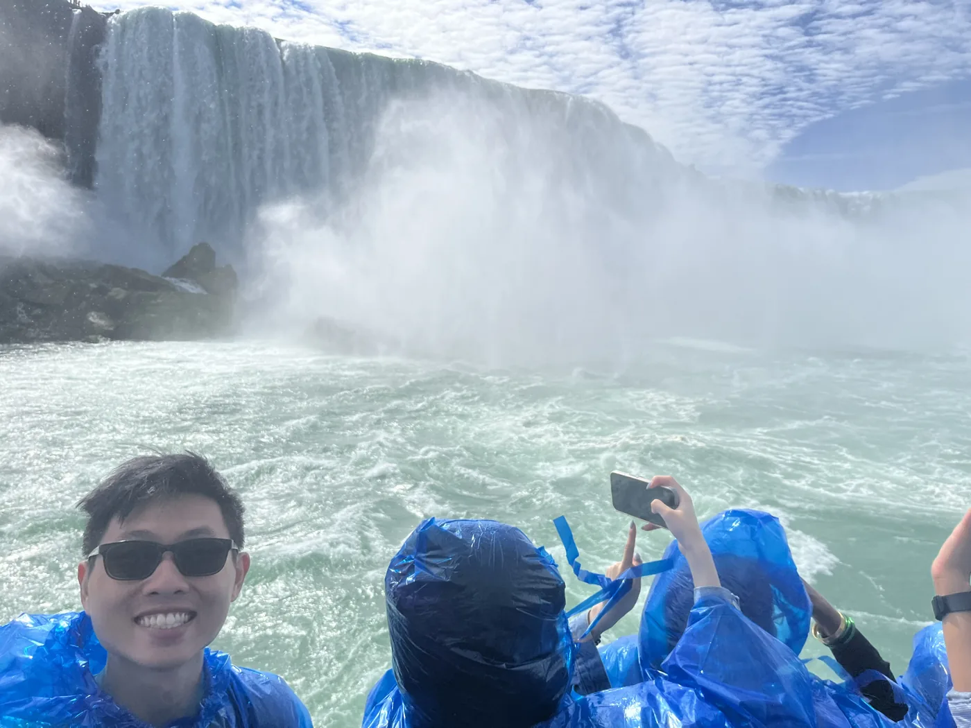 On the Maid of the Mist boat in blue ponchos at Horseshoe Falls