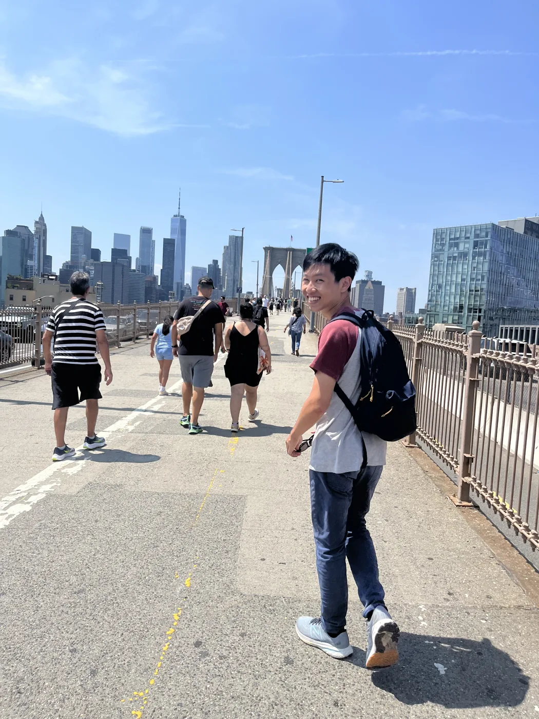 Walking on Brooklyn Bridge with Manhattan skyline behind
