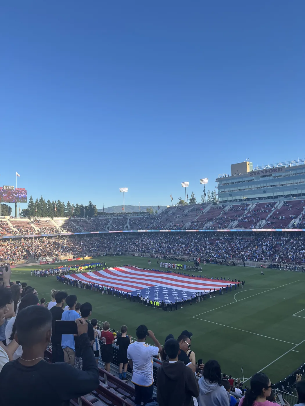 Stanford Stadium soccer match with giant US flag on field
