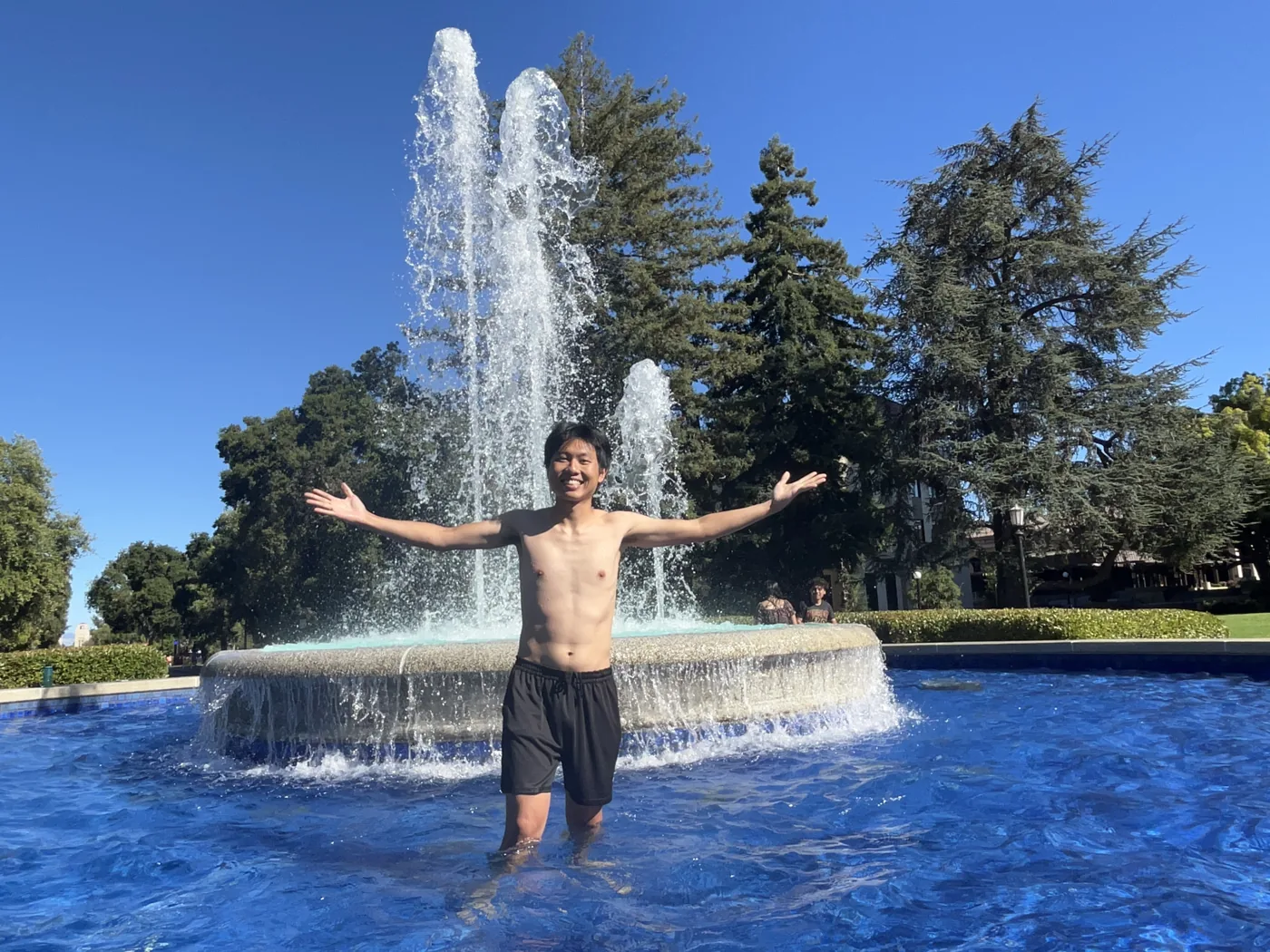 Standing in Stanford fountain with arms wide open
