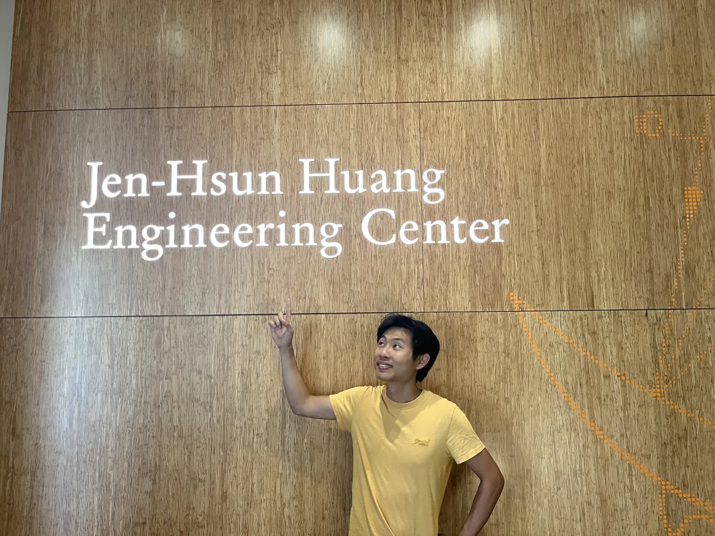 Pointing at Jen-Hsun Huang Engineering Center sign at Stanford