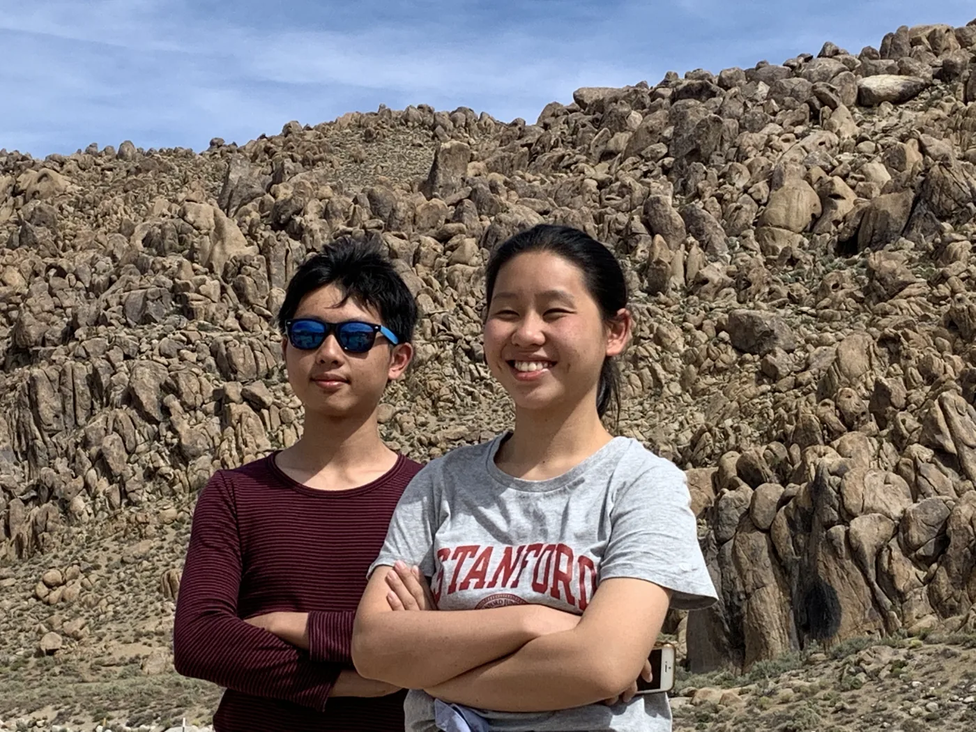 Two people posing among the giant granite boulders of Alabama Hills