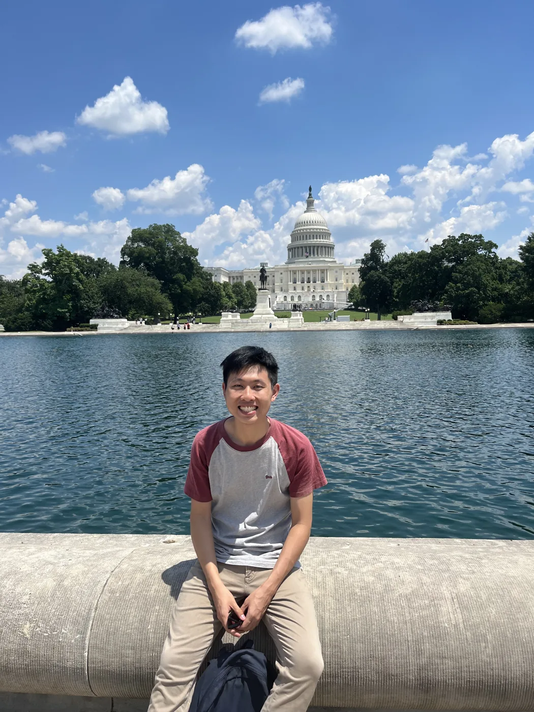 Sitting by the Capitol Reflecting Pool with US Capitol building behind
