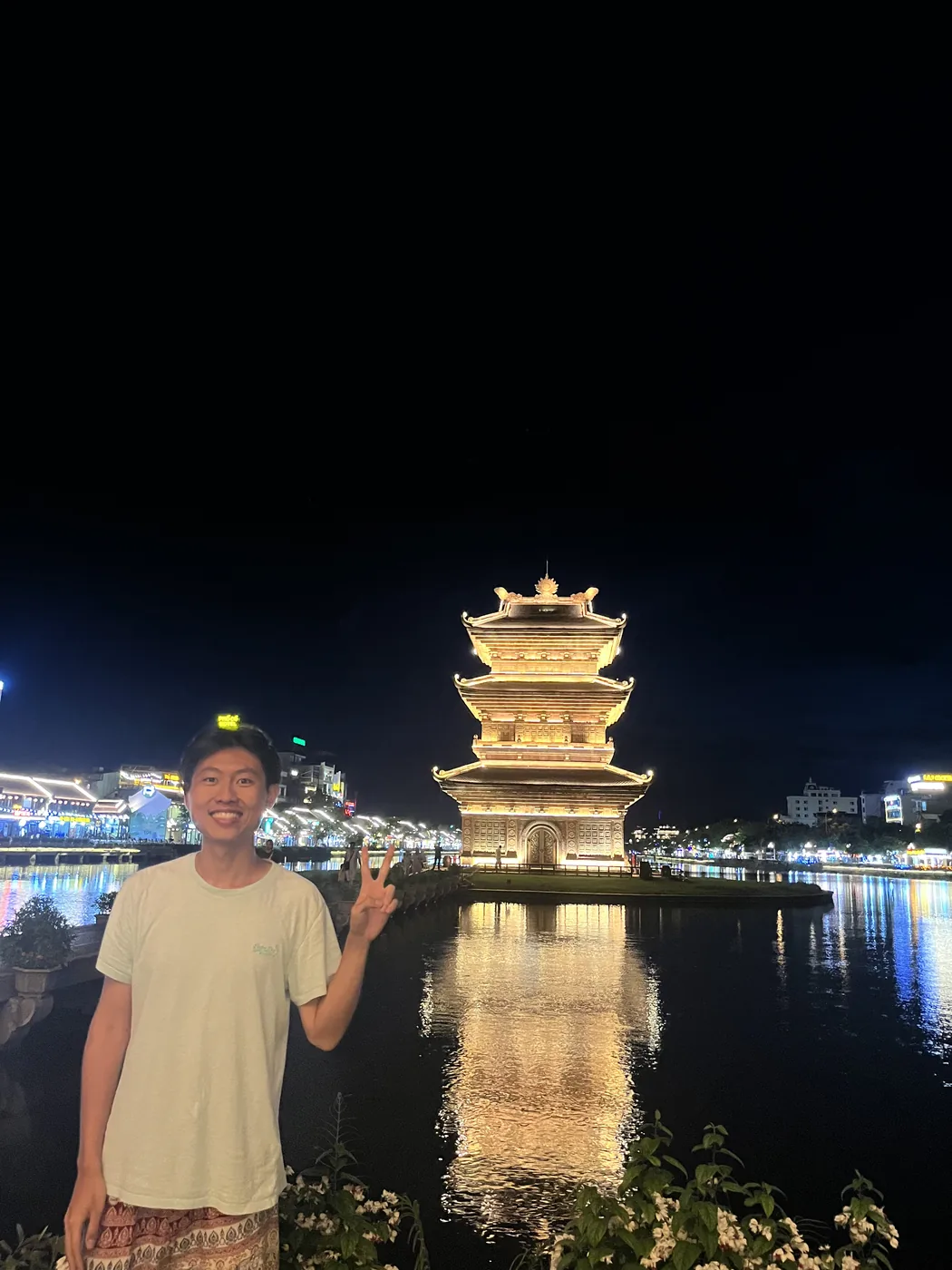 Golden pagoda tower illuminated at night, Ninh Binh