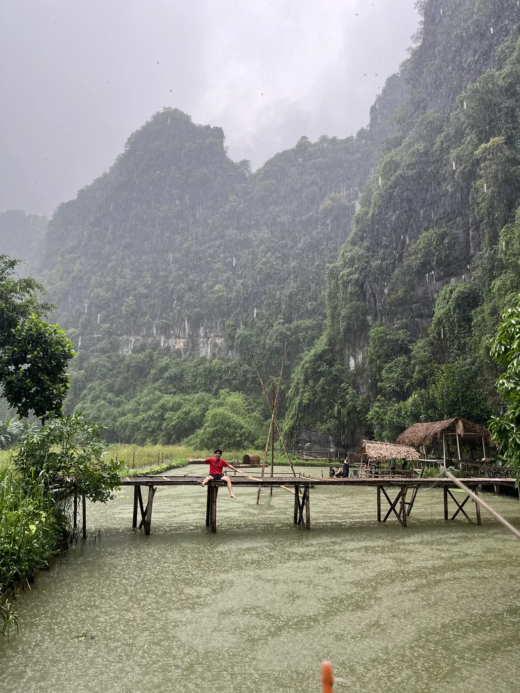 Sitting on a wooden dock in the rain, Ninh Binh